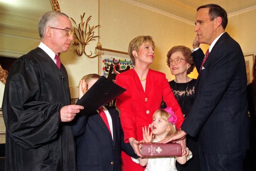 ** FILE ** Rudy Giuliani, right, is symbolically sworn-in as New York City Mayor by U.S. District Court Judge Michael B. Mukasey, left, during a private ceremony in New York in this Dec. 31, 1993 file photo. Giuliani's wife Donna Hanover, center, stands with their children Andrew, 7, and Caroline, 4; Giuliani's mother Helen looks on. President Bush has settled on Mukasey, a retired federal judge from New York, to replace Alberto Gonzales as attorney general and is expected to announce his selection Monday. (AP Photo/Ed Bailey, File)